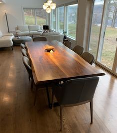 a large wooden table sitting in the middle of a living room