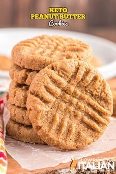 three peanut butter cookies stacked on top of each other in front of a white plate