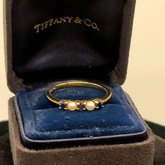 This Is A Beautiful Piece. It Features Three Blue Saphires And Two Pearls. My Daughter Never Wore It. It Comes With The Velvet Tiffany Co. Ring Presentation Box And Outer Tiffany Co. Blue Box. This Ring Is A Size 9.5. It Would Stack Well With Other Rings Or Make A Beautiful Statement On Its Own. Reposhing This And Several Other Items As My Daughter Was In An Accident And I Am Raising Money For Her Medical Bills. Medical Bills, Raising Money, Blue Sapphire Ring, Blue Box, The Velvet, Blue Sapphire Rings, Gold Pearl, How To Raise Money, Womens Jewelry Rings