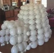 there are many white balloons in the living room