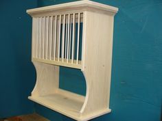 a wooden shelf sitting on top of a blue wall