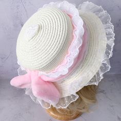 This elegant straw hat features a plush bow embellishment, intricately adorned with delicate lace trimmings. The hat's crown is further enhanced with a heart-shaped lace applique, adding a touch of charm and sophistication.  Please note: The price includes one hat only. Cute Adjustable Hat With Bow, Pink Bow Hat For Spring, Spring Straw Hat With Bow, Cute White Hats With Bow, Cute White Hat With Bow, White Beach Hat With Bow, White Hat With Ribbon And Short Brim, White Hat With Bow And Short Brim, White Short Brim Hat With Ribbon