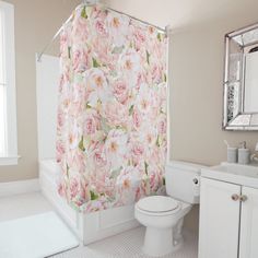 a pink shower curtain in a white bathroom