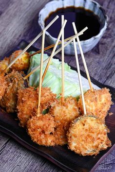 some food is sitting on a plate with toothpicks