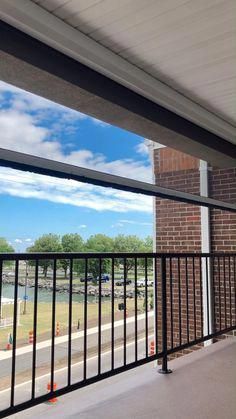 an empty balcony with black railings and blue sky