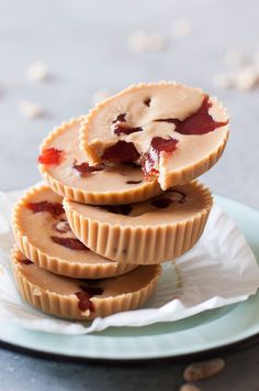 three peanut butter and jelly tarts stacked on top of each other in a plate