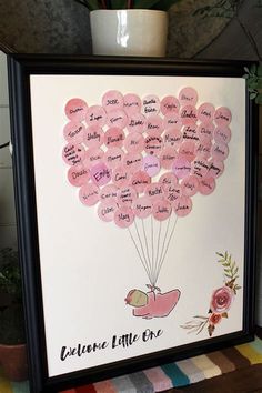 a pink balloon with the words welcome little one written on it in black framed frame