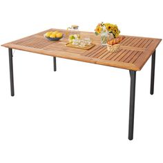 a wooden table topped with fruit and drinks