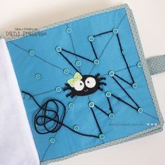 a close up of a piece of cloth with buttons on it and a spider in the center