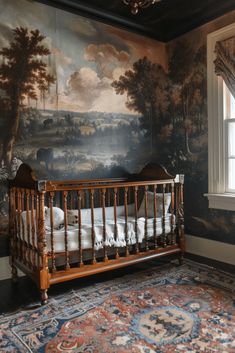 a baby's crib in front of a wall with a painting on it