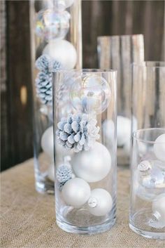 white balls and ornaments in clear vases on a table