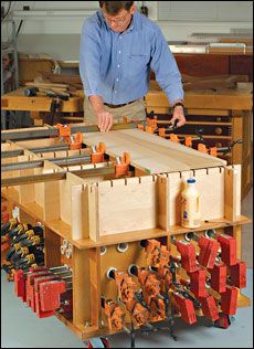 a man is working on an assembly line in a woodworking shop with lots of tools