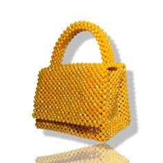 Artisanal Bead Bag.Designed in NYC. Crafted with precision in the heart of Lagos, Nigeria.Introducing our exclusive bead bags – the epitome of timeless elegance and craftsmanship. Chic, streamlined, and adaptable, these handbags are designed to be your enduring companions. Effortlessly blending style and durability, our bead bags transcend trends, seamlessly complementing cocktail dresses, casual denim and tees, professional attire, and becoming the perfect accessory for a night out on the town. Bead Bag, Lagos Nigeria, Professional Attire, Bag Light, Detail Shop, Beaded Bags, Light Orange, Casual Denim, Contemporary Fashion