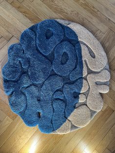 a blue and white rug on top of a hard wood floor next to a wooden floor