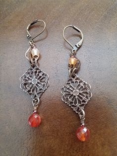 This earring design has a vintage, yet traditional look. Antique Brass lever backs give you the security to wear these and not of lose an earring. The small filigree on top cradles the light natural faceted Carnelian stone.  The diamond shaped Vintaj Brass filigree has been polished to reveal the golden color of natural Brass.  A faceted and natural dark orange Carnelian is layered on top. These Aged Brass Filigree connectors are Lead and Nickel free, Made in the USA. 20.00 Gift Box Included Tha Vintage Chandelier Dangle Earrings As Gift, Vintage Nickel Free Chandelier Earrings Gift, Vintage Chandelier Earrings As Gift, Vintage Earrings As A Gift, Vintage Dangle Chandelier Earrings As Gift, Handmade Metal Earrings For Vintage Collection, Vintage Chandelier Earrings For Gift, Vintage Style Metal Chandelier Earrings, Vintage Dangle Earrings For Vintage Collection