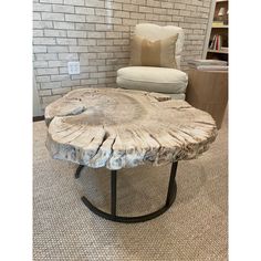 a wooden table sitting on top of a carpeted floor next to a white chair