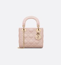 The Lady Dior bag embodies Dior's vision of elegance and beauty. Sleek and refined, the timeless and modern style is crafted in powder pink lambskin with Cannage stitching, creating the instantly recognizable quilted texture. Pale gold-finish metal D.I.O.R. charms further embellish and highlight its silhouette. Featuring a removable chain shoulder strap, the miniature Lady Dior bag can be carried by hand, worn over the shoulder or crossbody as an ideal evening wear companion.. Lady Dior My Abcdior Bag, Beautiful Wardrobe, Dream Bag, Dior And I, Book Bags, Dior Book Tote, Small Lady, Girly Bags, Christian Dior Couture