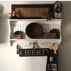 an old glory sign is hanging on the wall above a shelf with hats and other items