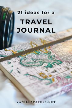 a camera sitting on top of a map with the words, 21 ideas for a travel journal