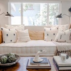 a living room filled with furniture and pillows