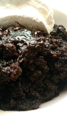 a close up of a plate of food with cake and ice cream on it's top