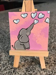 an elephant painting on a pink background with hearts