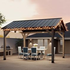 a covered patio with chairs and lights around it