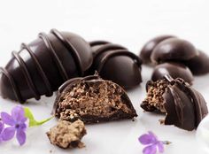 some chocolates and flowers on a white surface