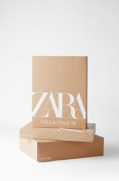 two cardboard boxes stacked on top of each other with the word zara printed on them