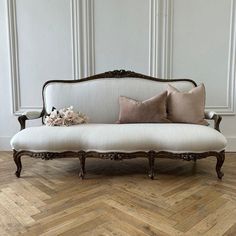 a white couch sitting on top of a wooden floor