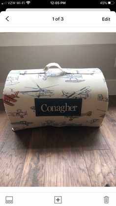 a white suitcase sitting on top of a wooden floor