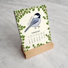 a calendar with a bird sitting on top of it