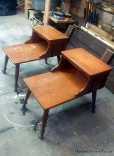 three wooden tables sitting next to each other on top of a cement floor in a garage