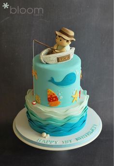 a blue birthday cake with an image of a boy fishing