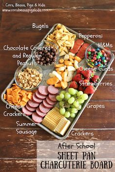 a tray filled with different types of food on top of a wooden table next to a sign