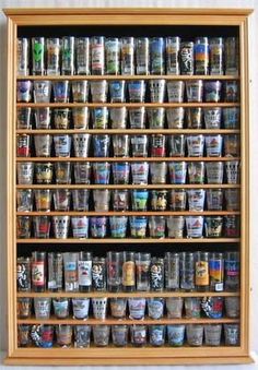 a wooden shelf filled with lots of different types of cups on it's sides