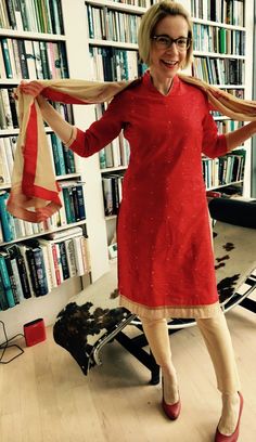 a woman standing in front of a bookshelf