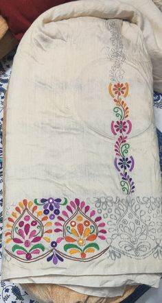 an embroidered cloth with colorful designs on it