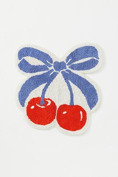 an embroidered patch with two cherries tied to it's sides and a bow on top