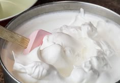 a spoon is in a bowl full of whipped cream