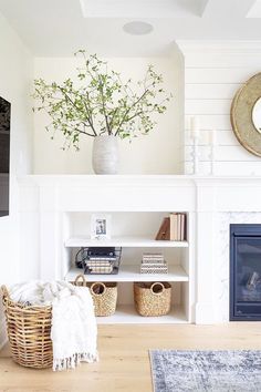 a living room filled with furniture and a fire place in front of a white fireplace