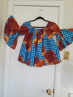 "Colorful 100% multi-colored cotton flared crop top for women's casual wear. Can be worn with a skirt or pants, or blue jeans. Flared hem and flared funnel sleeves with elastic around the arms.  Rectangular neck with elastic to keep it in shape. Measurements of the top: Length (shoulder to hem) 23 inches Sleeve length 16 inches - elasticated 8\" from neckline Hem width 50 inches Fits bust 34\" - 38\"" Multicolor Tops With Elastic Sleeves For Spring, Stretch Cotton Cropped Blouse, Summer Cotton Bell Sleeve Tops, Cotton Bell Sleeve Tops For Summer, Bohemian Cotton Tops With Bell Sleeves, Bohemian Cotton Top With Bell Sleeves, Multicolor Stretch Cotton Crop Top, Bohemian Bell Sleeve Cotton Top, Summer Cotton Blouse With Bell Sleeves