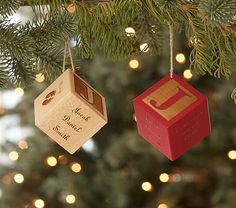 three wooden ornaments hanging from a christmas tree