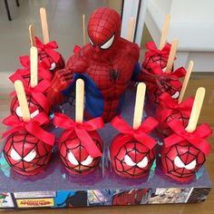 a spiderman themed cake with pops and candies in the shape of lollipops