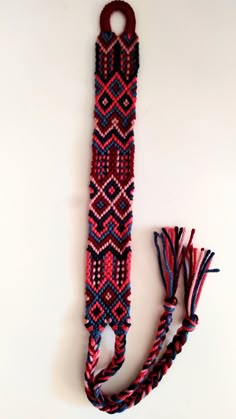 a red, white and blue beaded tie with tassels on it's end