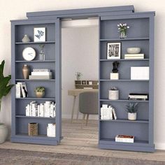 an open bookcase with several books on it and a plant in the corner next to it