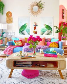 a living room filled with lots of colorful furniture and decor on top of a rug