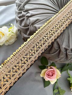 a close up of two different types of cloths on a bed with flowers in the background