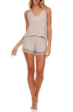 Ethereal lace trims a lightweight tank and shorts pajama set that brings feminine style and instant comfort to your evening. 2-piece set Top: 25" length; Shorts: 10" rise, 3" inseam (size S) Top: V-neck, sleeveless, back lace panel, solid color, knit construction Shorts: elasticized waist, pull-on style, solid color, nit construction, lace trim 62% polyester, 33% rayon, 5% spandex Machine wash cold Imported Model’s stats for sizing: 5’11” height, 32” bust, 24” waist, 34” hips. Model is wearing s Summer Sleepwear Sets In Short Style, Summer Sleepwear Short Set, Summer Sleep Sets With Short Length, Summer Sleep Sets In Short Length, Summer Beige Sleep Sets, Spring Lounging Short Sets, Stretch Vacation Sets With Shorts, Stretch Short Sets For Vacation, Flora Nikrooz