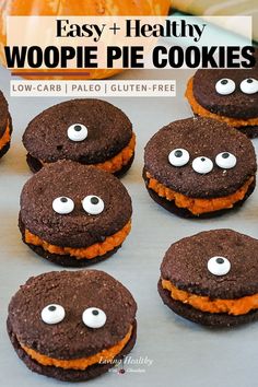 chocolate cookies with googly eyes are on a baking sheet for halloween party treat ideas